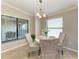Bright dining area features a round table with four rattan chairs and a window at 5577 Palmer Cir # 203, Bradenton, FL 34211