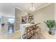 Charming dining area with a wooden table, bar stools, and easy access to the modern kitchen at 5577 Palmer Cir # 203, Bradenton, FL 34211