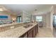Beautiful kitchen with granite countertops, a breakfast bar, and stainless steel sink at 5577 Palmer Cir # 203, Bradenton, FL 34211