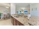 Granite countertops accent this lovely kitchen, overlooking the open-concept living area at 5577 Palmer Cir # 203, Bradenton, FL 34211