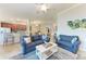 Open-concept living area with modern furniture, connecting to dining and kitchen at 5577 Palmer Cir # 203, Bradenton, FL 34211