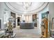 Elegant lobby featuring a curved reception desk, chic decor, display shelves, and a modern chandelier at 5577 Palmer Cir # 203, Bradenton, FL 34211