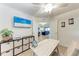 Well-lit office space with a desk, storage unit, and view of the living room, offering a functional workspace at 5577 Palmer Cir # 203, Bradenton, FL 34211