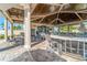 Outdoor bar and seating area with elegant finishes, ceiling fans, and comfortable seating for entertaining guests at 5577 Palmer Cir # 203, Bradenton, FL 34211