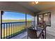 Comfortable patio with relaxing views of the lake, complemented by a glass-topped table and woven chairs at 5577 Palmer Cir # 203, Bradenton, FL 34211