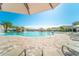 Resort-style pool with water features, palm trees, and lounge chairs in a stunning community setting at 5577 Palmer Cir # 203, Bradenton, FL 34211