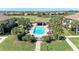 Aerial view of community pool featuring a pool with lounge chairs, a covered gazebo, and lush tropical landscaping at 5577 Palmer Cir # 203, Bradenton, FL 34211