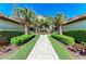 Paver walkway leading to the residence, surrounded by lush tropical landscaping at 5577 Palmer Cir # 203, Bradenton, FL 34211