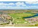 Expansive golf course and neighborhood aerial view, featuring lush fairways, water features, and pristine landscaping at 5695 Palmer Cir # 101, Bradenton, FL 34211