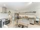 Modern kitchen featuring stainless steel appliances, open shelving, and a tiled backsplash at 57 N Shore Dr, Anna Maria, FL 34216