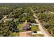 Aerial view of the home and the surrounding area showcasing a white fence and large backyard at 5757 Jonesboro Ave, North Port, FL 34288