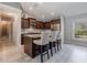 Modern kitchen with an island and breakfast bar with stylish white barstools at 5757 Jonesboro Ave, North Port, FL 34288