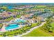 Aerial view of the clubhouse, pool and tennis courts at 5931 Wake Forest Run # 104, Bradenton, FL 34211