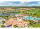 Aerial view of residential homes, tennis courts, a clubhouse, and golf course at 5931 Wake Forest Run # 104, Bradenton, FL 34211