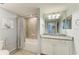 Bathroom featuring a bath tub with tiled shower, vanity with granite countertop, and a large mirror at 5931 Wake Forest Run # 104, Bradenton, FL 34211