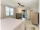 A sunlit main bedroom features neutral tones, a ceiling fan, and sliding glass doors to an outdoor patio at 5931 Wake Forest Run # 104, Bradenton, FL 34211