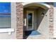 Close-up of the entryway, featuring a glass door, stone accents, and a charming mailbox at 5931 Wake Forest Run # 104, Bradenton, FL 34211