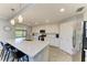 Modern kitchen with quartz countertops, stainless steel appliances, a breakfast bar, and tile flooring at 5931 Wake Forest Run # 104, Bradenton, FL 34211