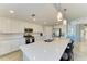 Spacious kitchen with a large quartz island, stainless steel appliances, and stylish pendant lighting at 5931 Wake Forest Run # 104, Bradenton, FL 34211
