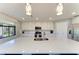 Bright kitchen featuring a quartz island, stainless steel appliances, pendant lighting, and ample cabinet space at 5931 Wake Forest Run # 104, Bradenton, FL 34211