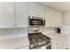Close-up of a modern kitchen with stainless steel appliances, quartz countertops, and white subway tile backsplash at 5931 Wake Forest Run # 104, Bradenton, FL 34211