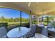 Comfortable screened lanai featuring a table and chairs, perfect for outdoor dining and relaxing at 5931 Wake Forest Run # 104, Bradenton, FL 34211