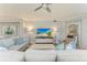 Comfortable living room with neutral tones, a large sofa, and a view into another room at 5931 Wake Forest Run # 104, Bradenton, FL 34211