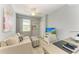 Cozy living area with sofa, desk, and television, perfect for relaxation and work at 5931 Wake Forest Run # 104, Bradenton, FL 34211