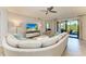 Spacious living room featuring a comfortable sofa, entertainment center, and lots of natural light at 5931 Wake Forest Run # 104, Bradenton, FL 34211