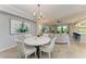 Open living space with a dining area, comfortable seating, and access to outdoor views at 5931 Wake Forest Run # 104, Bradenton, FL 34211