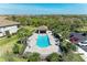 Scenic aerial shot of the community pool featuring a gazebo, lounge seating and nearby parking at 5931 Wake Forest Run # 104, Bradenton, FL 34211