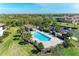 Aerial view of a beautiful community pool with a gazebo and ample lounge space at 5931 Wake Forest Run # 104, Bradenton, FL 34211