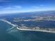 Stunning aerial view of coastline community near the ocean under blue skies at 640 Fox St, Longboat Key, FL 34228