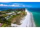 Panoramic aerial view of a coastal community with a sandy beach and turquoise water, a perfect seaside escape at 640 Fox St, Longboat Key, FL 34228