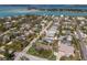 Residential area aerial view with partial views of the water, houses, green lawns, and lush trees at 640 Fox St, Longboat Key, FL 34228