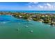 Breathtaking aerial view of a coastal community with boats sailing on clear waters and lush green surroundings at 640 Fox St, Longboat Key, FL 34228