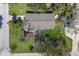 Aerial view of a landscaped single-Gathering home showing the roof, lawn and surrounding trees at 640 Fox St, Longboat Key, FL 34228