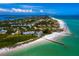 Stunning aerial view of a coastal neighborhood featuring white sand beaches and clear turquoise water at 640 Fox St, Longboat Key, FL 34228
