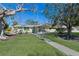Inviting single-story home featuring a screened porch and a walkway leading to the front entrance at 640 Fox St, Longboat Key, FL 34228