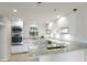 Modern kitchen featuring sleek white cabinets, granite countertops, and stainless steel appliances at 640 Fox St, Longboat Key, FL 34228