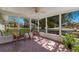 Inviting screened porch featuring comfortable seating, patterned tile, and tranquil garden views at 640 Fox St, Longboat Key, FL 34228