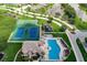 Aerial view of community amenities showcasing pool, tennis and basketball courts, playground, and surrounding landscape at 6709 Rock Bridge Ln, Ellenton, FL 34222