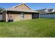 Backyard featuring a screened-in patio and ample green space at 6709 Rock Bridge Ln, Ellenton, FL 34222