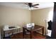 Well-lit bedroom featuring sleek ceiling fan, hardwood floors, sewing station, and bright natural light at 6709 Rock Bridge Ln, Ellenton, FL 34222