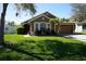 Charming single-story home with well-manicured lawn, lush landscaping, and a two-car garage at 6709 Rock Bridge Ln, Ellenton, FL 34222