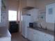 The kitchen features white cabinetry, modern appliances, and ample counter space at 6709 Rock Bridge Ln, Ellenton, FL 34222