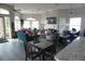 Open lounge area with comfortable seating, dining tables, TV, and ample natural light for relaxation and socializing at 6709 Rock Bridge Ln, Ellenton, FL 34222