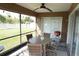 Screened patio with a ceiling fan, dining table set and a grill for outdoor cooking and entertaining at 6709 Rock Bridge Ln, Ellenton, FL 34222