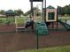 Community playground with a climbing wall, slide, and other play structures in a fenced area at 6709 Rock Bridge Ln, Ellenton, FL 34222