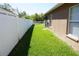 Grassy side yard enclosed by a white fence, offering privacy and space at 6709 Rock Bridge Ln, Ellenton, FL 34222